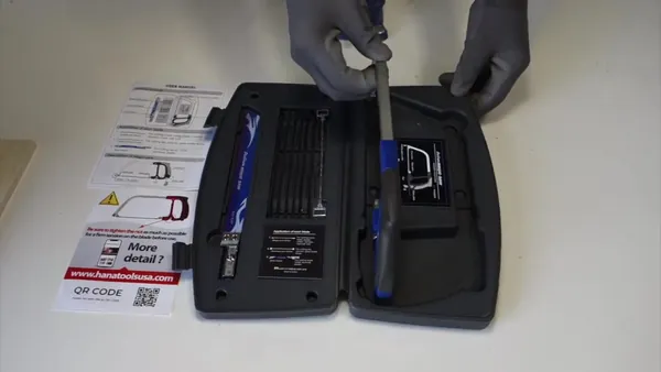 The Magic Saw kit in its black carrying case with blue saw frame and blades