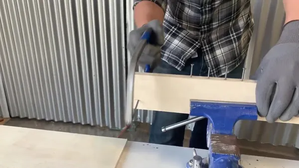 Cutting a wood board held in a vise